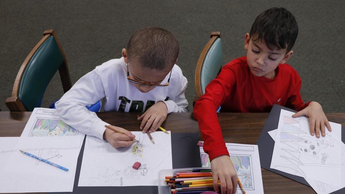 Cousins, Kashe (left) and Bentley Lynch, 8, both of Lee’s Summit, worked side-by-side during Saturday’s “Draw Like Rousseau” program held at the Lee’s Summit Library.