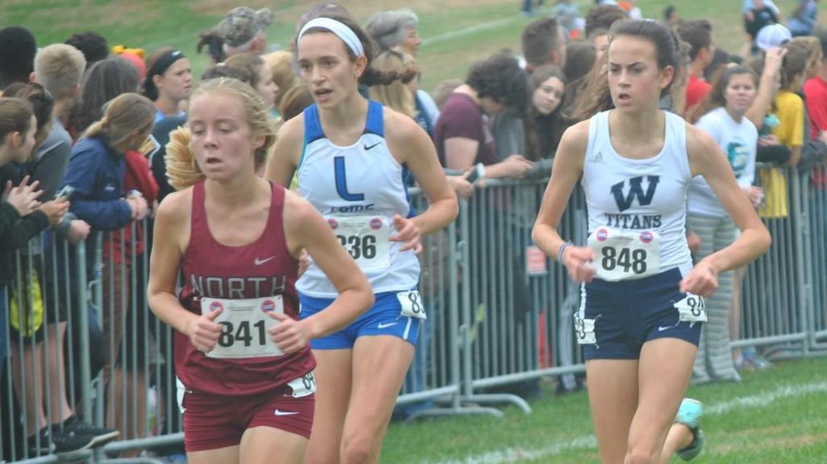 Madelyn Robinson (left) of Lee’s Summit North and Madison Hulsey of Lee’s Summit West head for the finish line in the Class 4 girls race at the state cross country meet Nov. 4 in Jefferson City. Hulsey finished 19th and Robinson placed 20th to earn all-state honors.