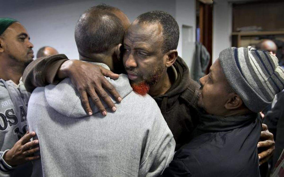 Abdullahi Mohamud (center), father of Abdisamad Sheikh-Hussein, was consoled after prayers on Friday at the Somali Center of Kansas City.