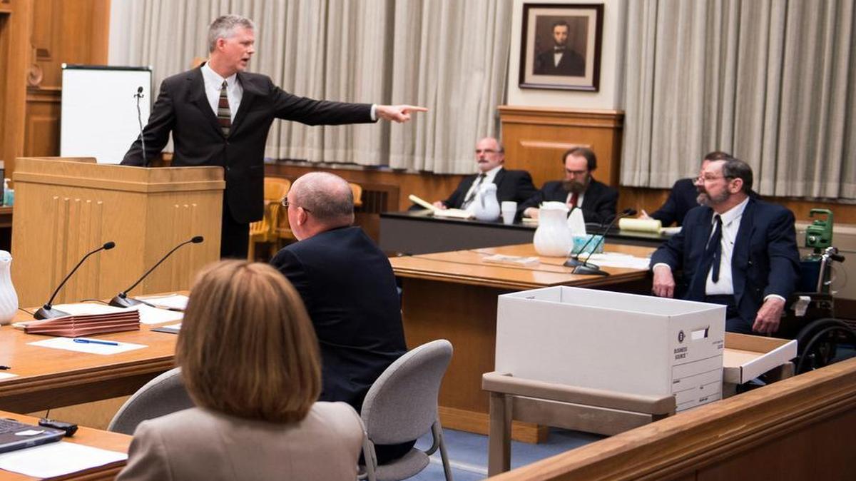 
Testimony began Monday in Olathe in the capital murder trial of F. Glenn Miller Jr., in the fatal shootings of three people on April 13, 2014, outside the Jewish Community Center and the Village Shalom retirement community in Overland Park. Chief Deputy District Attorney Chris McMullin (standing at the podium) gave his opening statements while Miller, who is acting as his own attorney, sat in a wheelchair.

