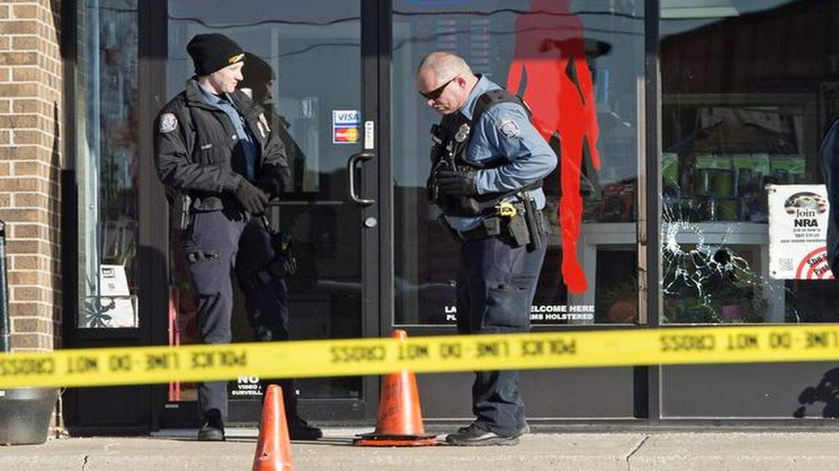 
Police were on the scene of a shooting Friday outside of She's A Pistol, a firearms store at 5725 Nieman Rd., in Shawnee on Friday, Jan. 9, 2015. Three men were shot and a woman was assaulted. Bullets holes can be seen in the store's front window.
