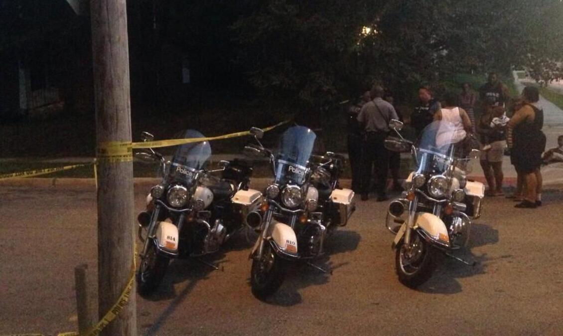 Police spoke with residents after a shooting Wednesday evening near 40th and Olive streets in Kansas City. A man was pronounced dead at the scene.