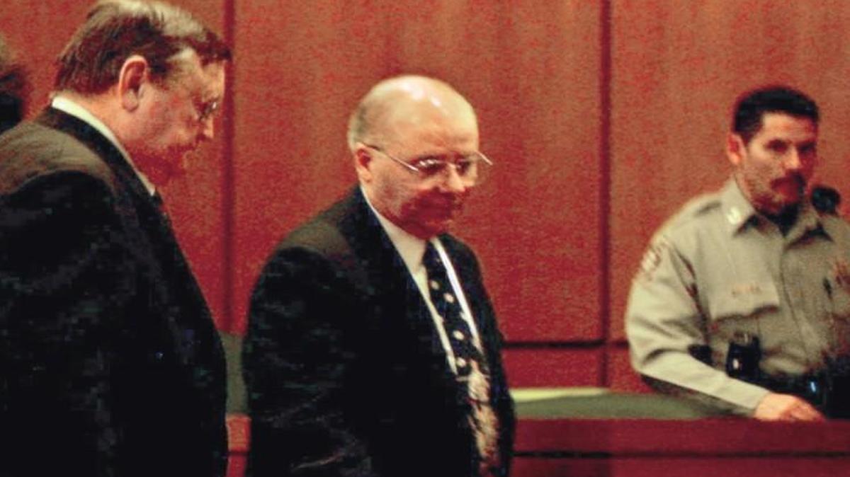 John E. Robinson Sr. (center) was convicted of killing eight women between 1984 and 2000. The bodies of many of his victims were found in barrels.