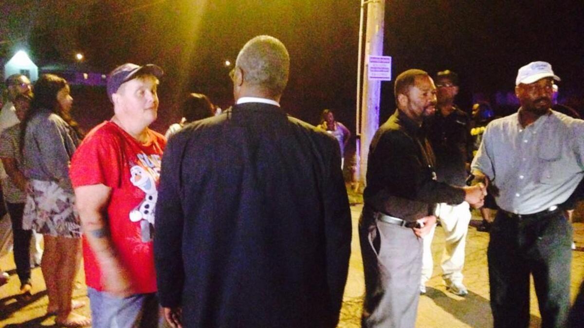 
Kansas City Mayor Sly James and Chief of Police Darryl Forté talked with neighbors at the scene of a reported shooting where three people were found dead in a home. 
