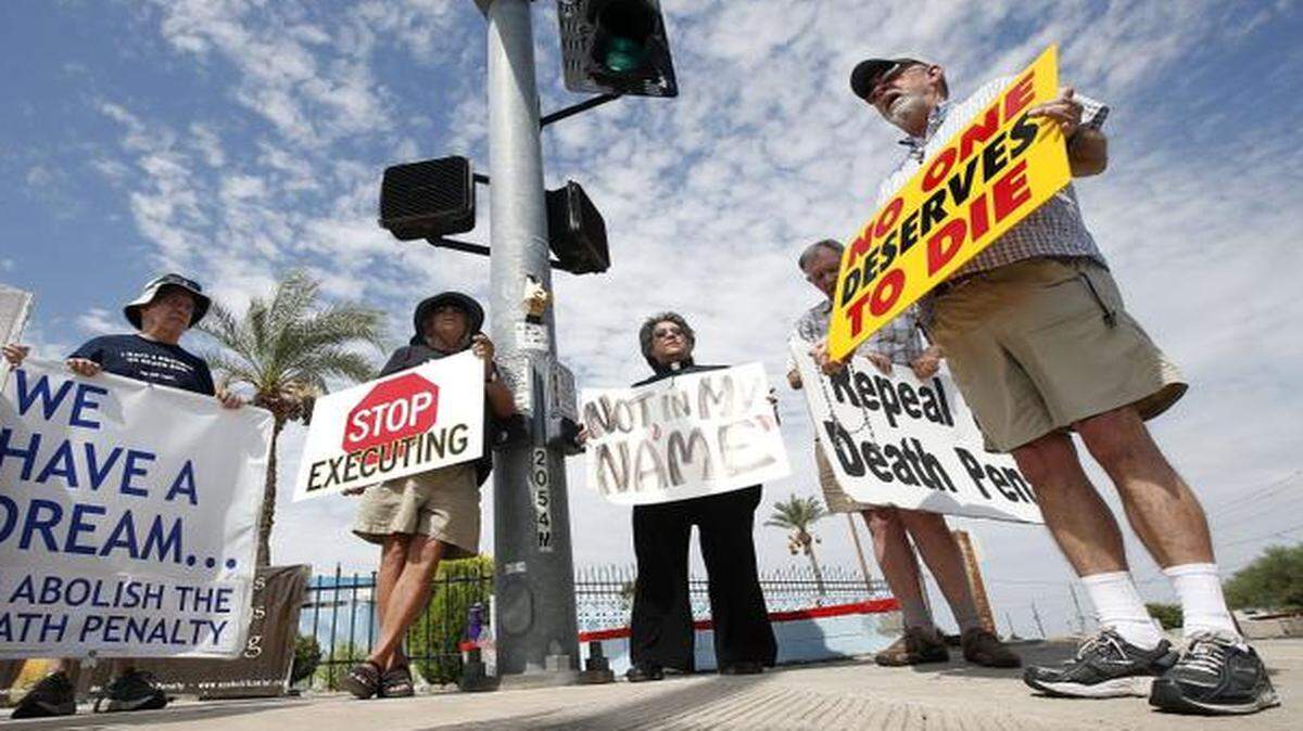 
A group of about a dozen death penalty opponents protested before the July 23 execution of Joseph R. Wood III at the state prison in Florence, Ariz. 
