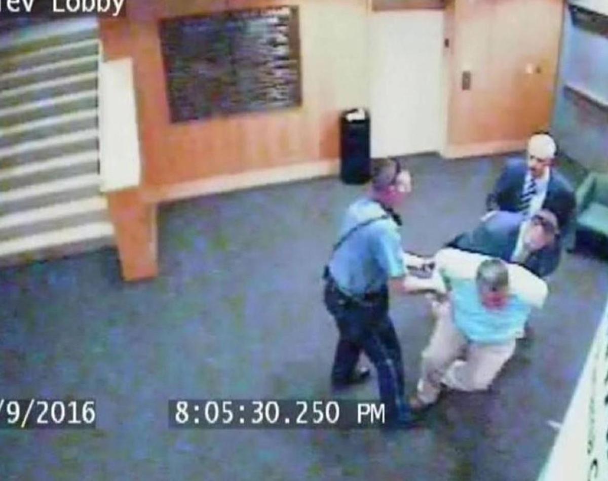 A Kansas City Public Library surveillance camera showed the arrest of library employee Steve Woolfolk. Kansas City police said Woolfolk interfered with the arrest of a library patron who made comments at a public event.