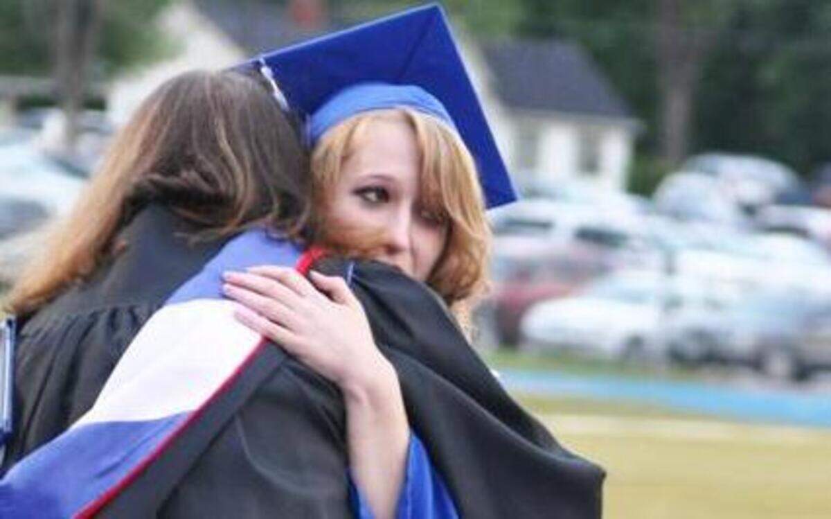 Teacher Annetta Marie Snowden gave Hannah Welhoff a hug after she received her diploma.