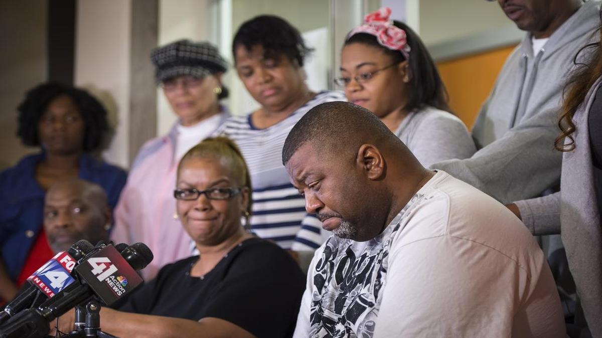 
Eric McKinney (lower right) wept at the memories of his grandson, Amorian S.L. Hale, 3, who was killed by gunfire about 10 a.m. Sunday in the 6700 block of Walrond Avenue in Kansas City. 
