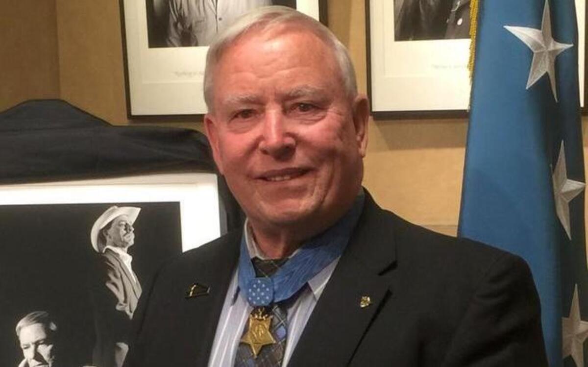 Don Ballard, a Medal of Honor recipient, had $100,000 in cash, commemorative military awards and coins stolen from his Grain Valley business Sunday.