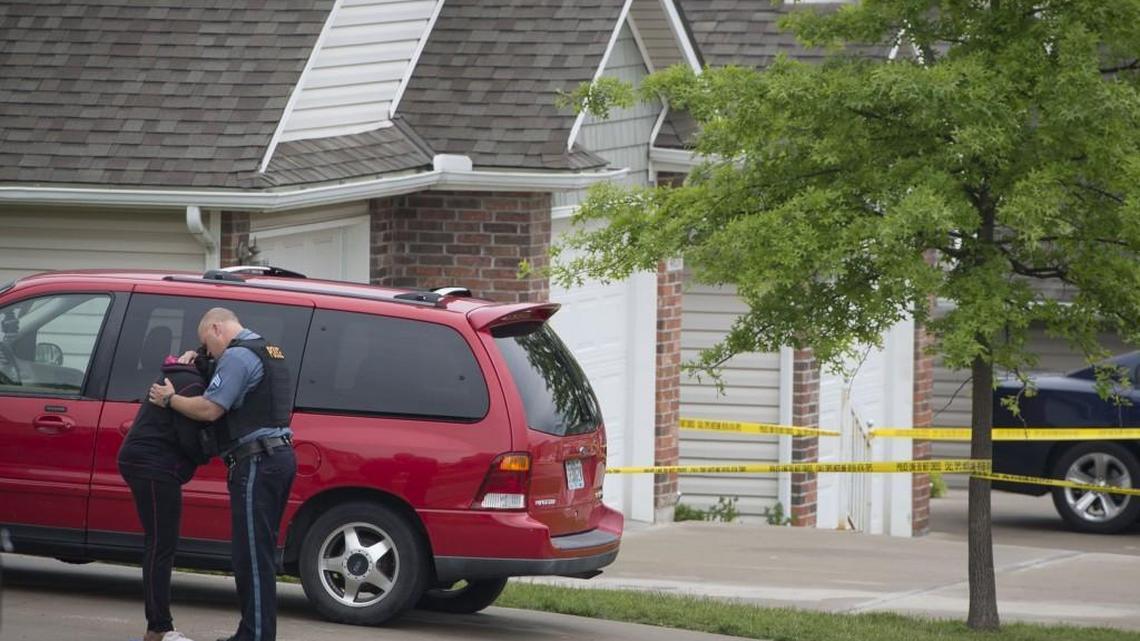 Kansas City Police officer comforts a family member as detectives investigated the scene of a shooting in the 4600 block of Willow in May in Kansas City. Late Tuesday, Kansas City recorded its 121st homicide of 2016. The number of homicides recorded so far this year in Kansas City is the highest since 2008.