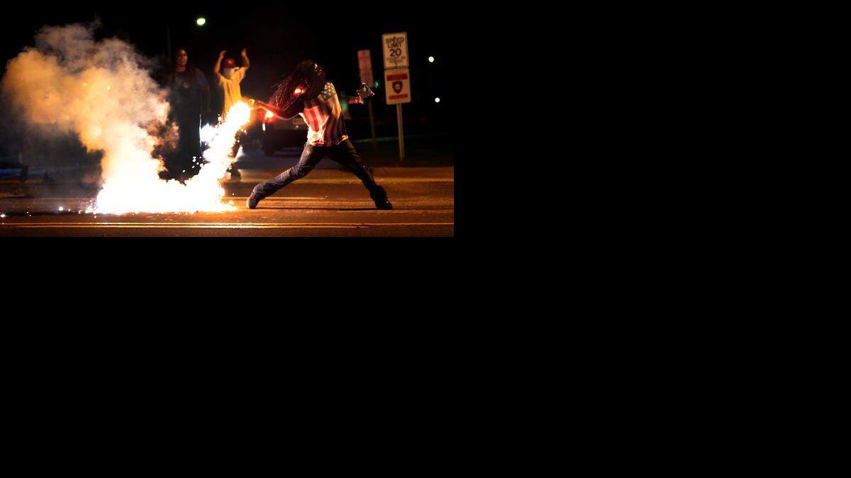 
After recurring protests and destruction in Ferguson, Mo., like this scene Wednesday, officials on Saturday imposed a midnight to 5 a.m. curfew in the city northwest of St. Louis. 
