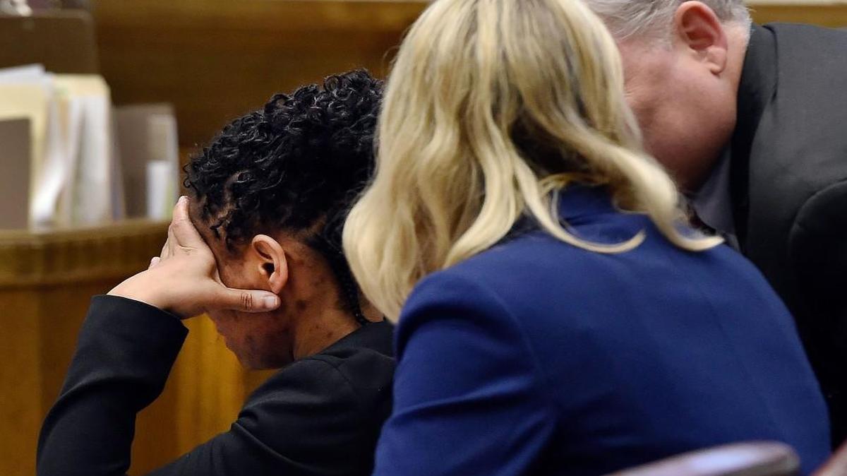 At her trial Tuesday, Jacole Prince (left) held her head in her hand while her lawyers, Cailin Stephenson and Curtis Winegarner, conferred shortly after Prince’s daughter, known as LP, testified in Jackson County Circuit Court. Prince is charged with felony child endangerment, first-degree assault and child abuse stemming from 2012, when her daughter, then age 10, was found locked in a closet and severely malnourished.