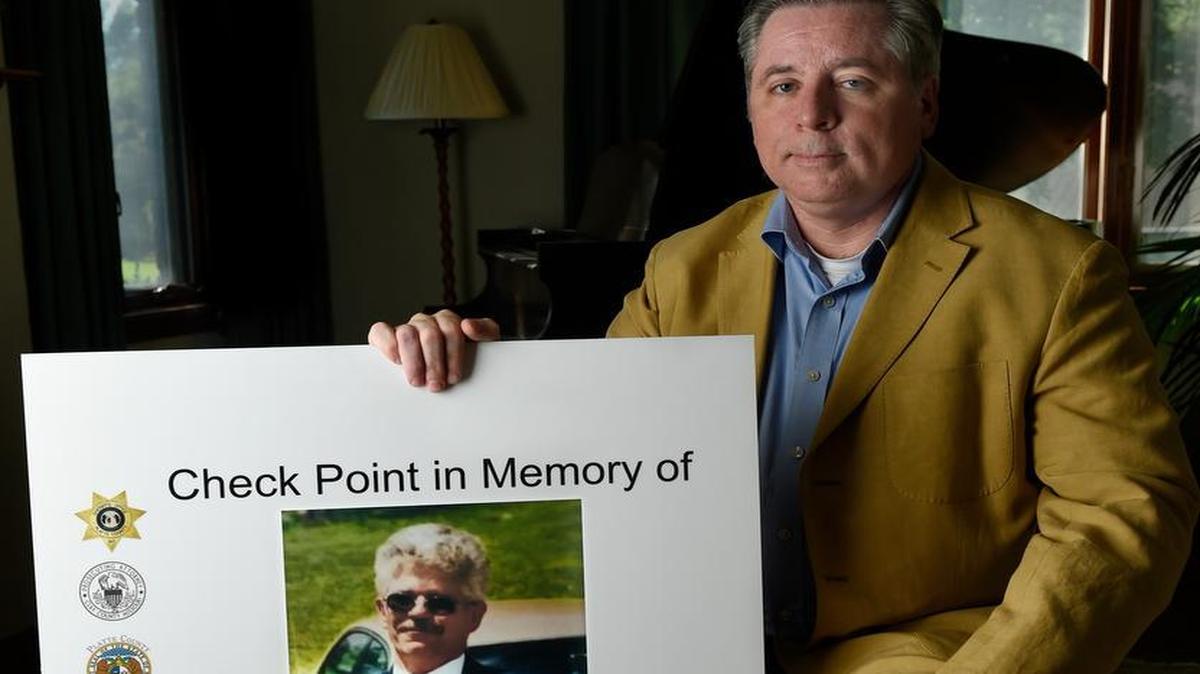 
Two DUI checkpoints in the Northland this weekend will be conducted in memory of Don Rippy, who died in an accident caused by a man driving under the influence. Drivers at the checkpoints will see a photo of Rippy on a poster like that held by Platte County Prosecutor Eric Zahnd.

