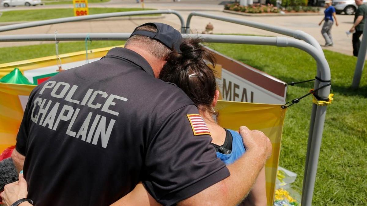 Robert Ossler, a police chaplain from New Jersey who had come for support, comforted Baton Rouge, La., resident Stacey DeJohn while she dropped off flowers in memory of the three slain police officers on Monday.