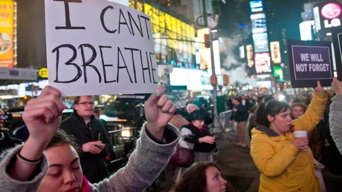 
Protesters in New York’s Times Square carried signs Wednesday night protesting a grand jury’s decision no to indict a police officer in the death of Eric Garner, an unarmed black man who was put in a chokehold after he was stopped for selling loose, untaxed cigarettes. A small protest also was held Wednesday night in Kansas City.

