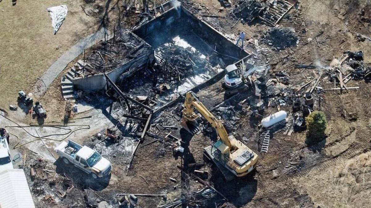 Investigators used heavy equipment to examine the remains of a house that burned Feb. 19 and killed four people just south of Edgerton, Mo.