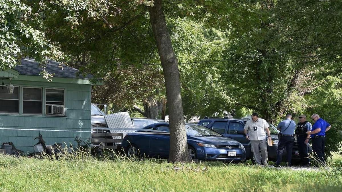 A woman was fatally shot in a home Friday in the 5700 block of Cambridge Avenue in Kansas City. Investigators worked the scene.