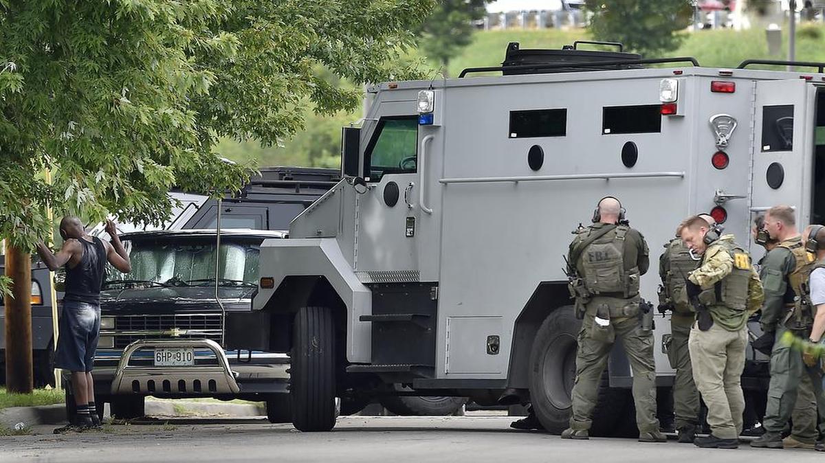 
A man (left) thought to be Willie E. Parker, who is charged with murder in the shooting death of Michel Ziade, surrendered to authorities Thursday evening near the 2700 block of Highland Avenue in Kansas City.

