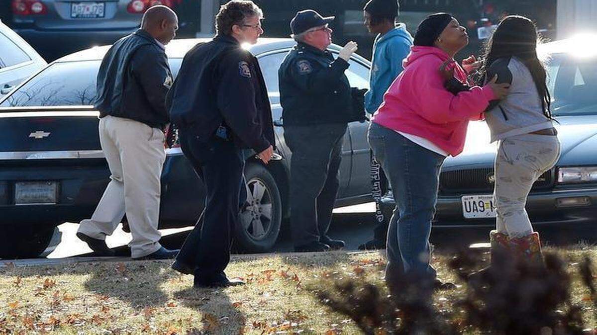 
Friends and family of a homicide victim consoled one another at the Wilshire Apartments in Liberty.
