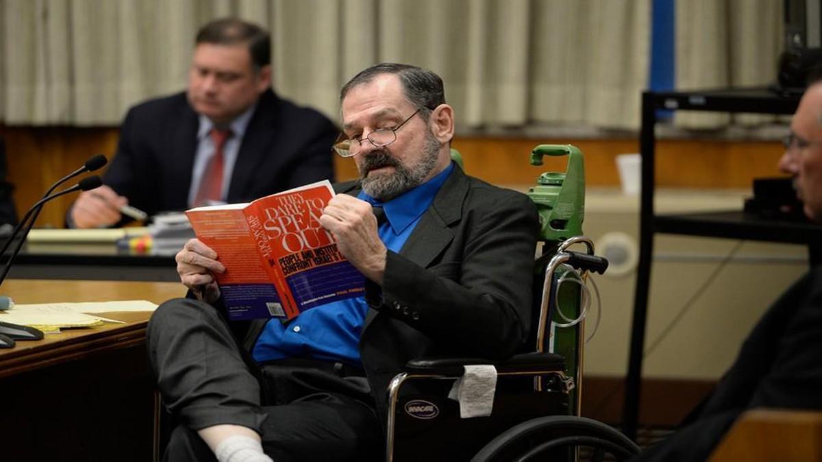 
 F. Glenn Miller Jr. reviewed a book during his capital murder trial at Johnson County District Court in Olathe on Tuesday.
