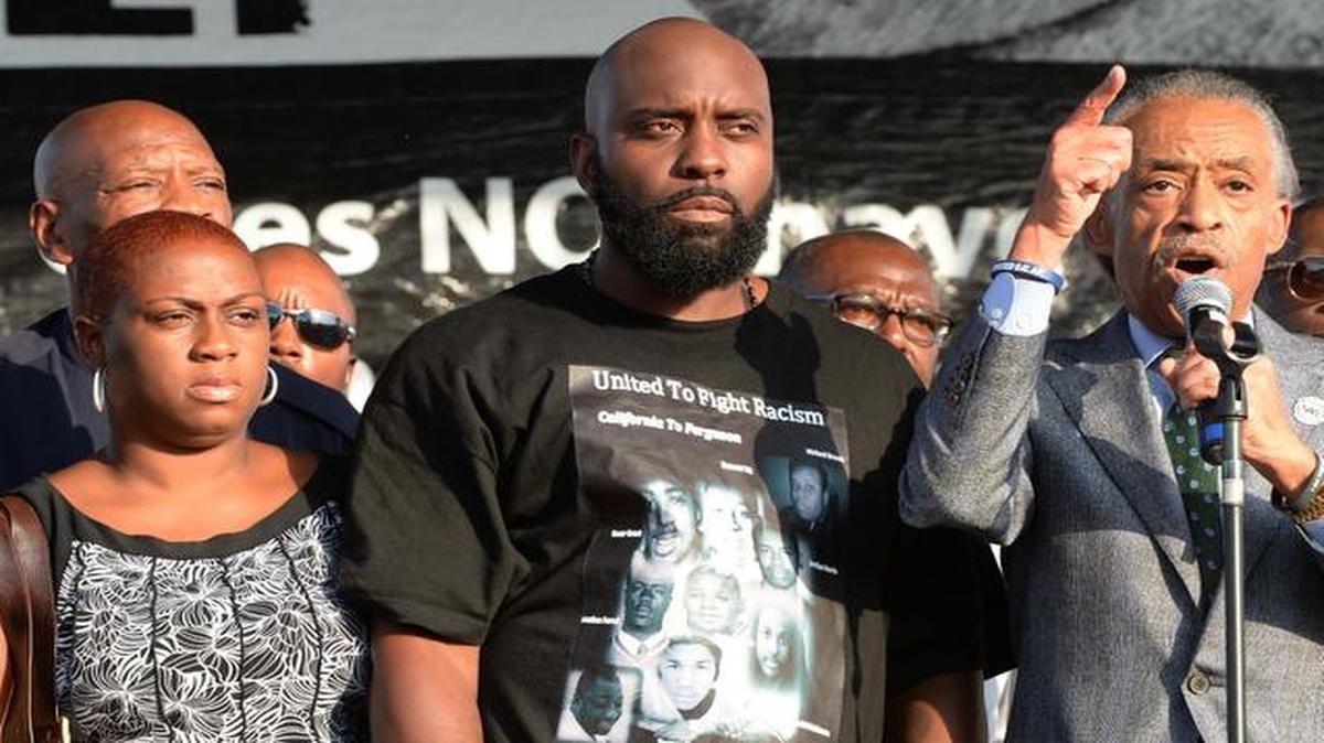 
At the Peace Fest 2014 event Sunday in St. Louis, the Rev. Al Sharpton (right) introduced the parents of slain teen Michael Brown, Lesley McSpadden (left) and Michael Brown, Sr. 
