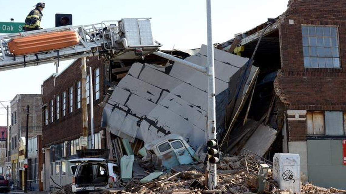 
A firefighter on a ladder truck inspected the damage to a building at 18th and Oak streets after a vehicle involved in a police pursuit crashed into the building last month.


