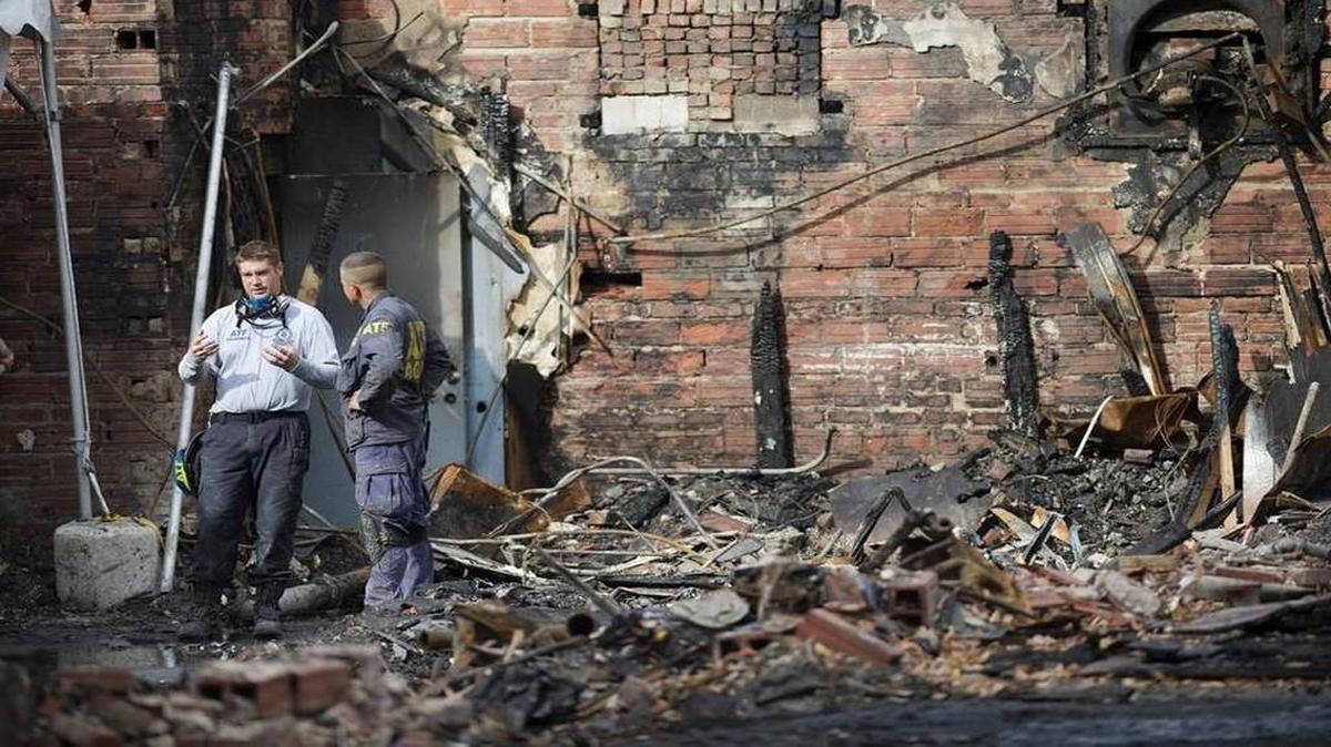Federal investigators continued their methodical work at the scene of the Oct. 12 fire on Independence Avenue near Prospect Avenue that killed two firefighters.