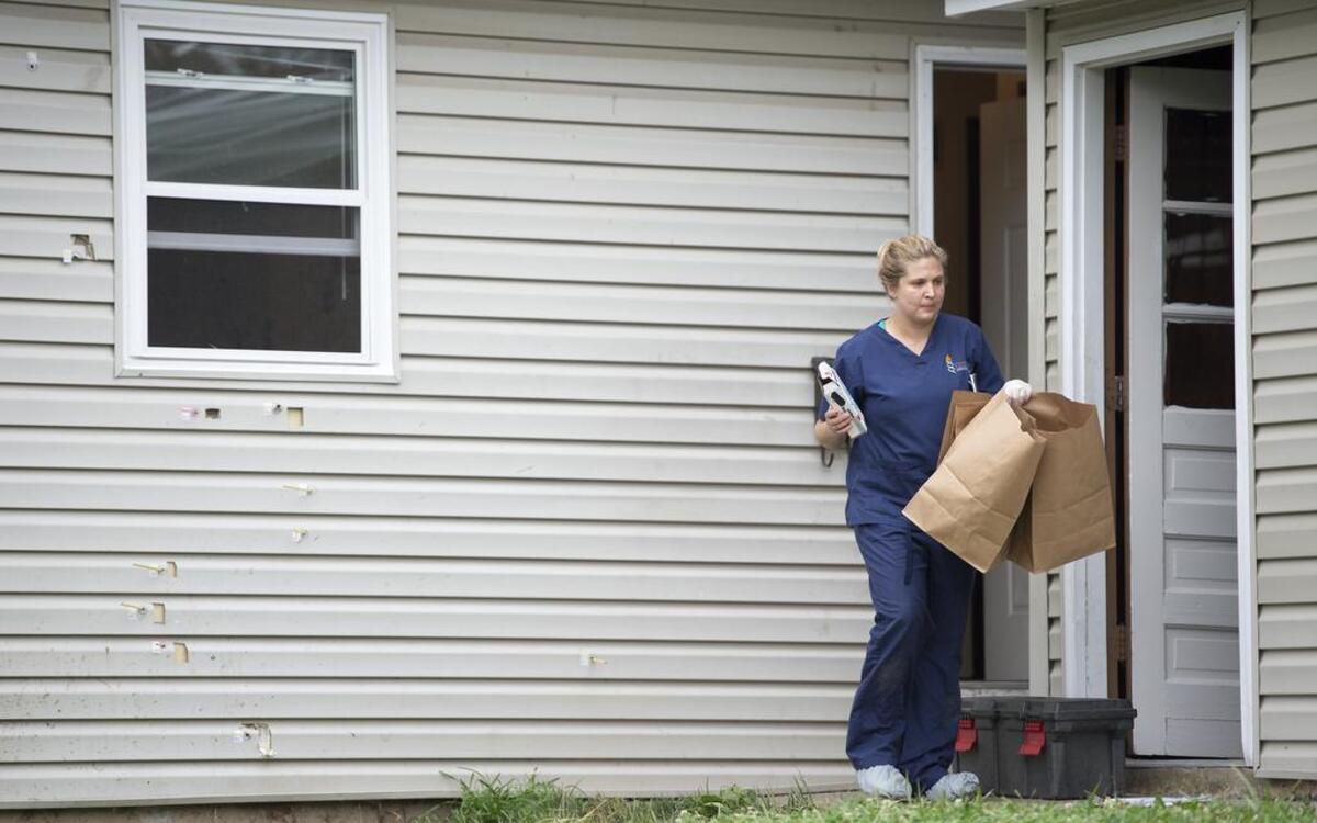 
Bullet holes riddled the side of a duplex in the 7800 block of West 61st Terrace in Overland Park as crime scene investigator Ashley Vogelaar of the Johnson County sheriff’s department carried bags out of the duplex on Tuesday while processing the scene.
