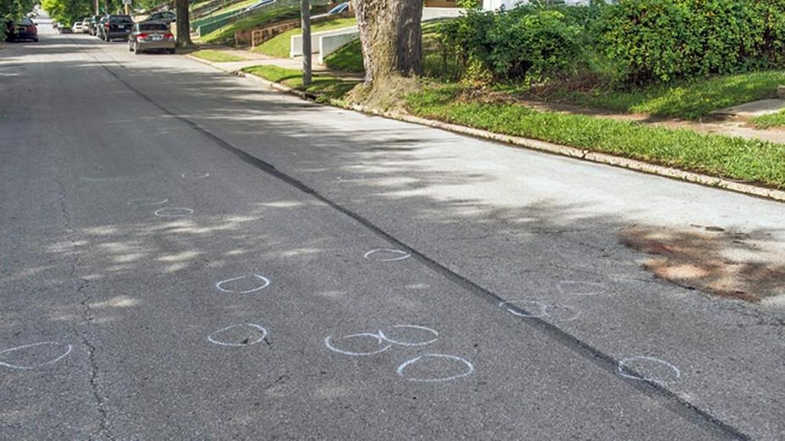 Evidence markers and blood stains were what remained Sunday after a double homicide Saturday night on Myrtle Avenue near 28th Terrace in Kansas City.