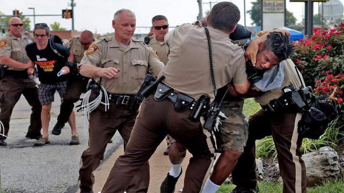
Police on Monday tackled a man who was walking in front of a McDonald’s restaurant Monday in Ferguson, Mo. The man appeared to be walking past a group that had been assembled nearby, and police were telling everyone to keep walking. Moments after he turned and told the police that he was just walking, officers took him to the ground. Police have told protesters to keep moving or face arrest.
