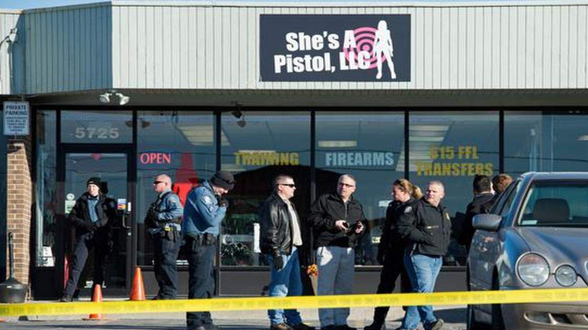 
Police gathered Friday outside She’s A Pistol, a gun store in Shawnee, after four people were shot there. The store’s co-owner died, and three robbers were wounded. 
