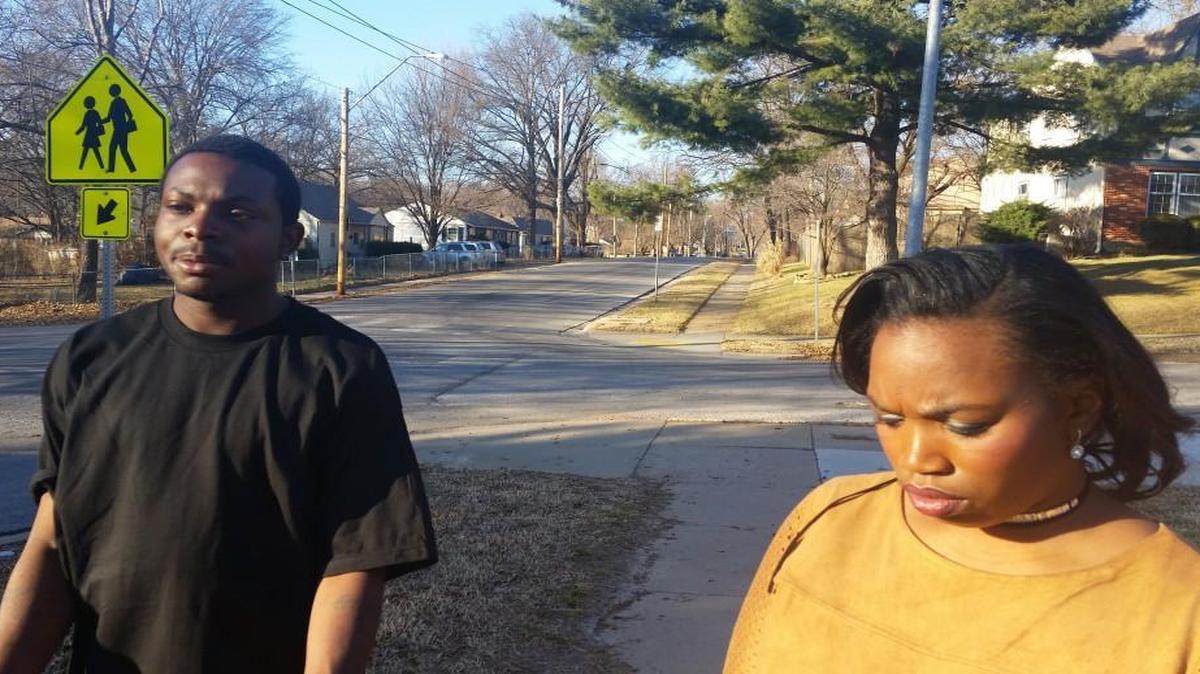 Brandon Robins (left) returned Saturday to the intersection of 81st and Oak streets, where on Tuesday he was arrested on an outstanding warrant for a minor traffic offense after a neighbor called police. Tasha James is Robins’ spokeswoman.