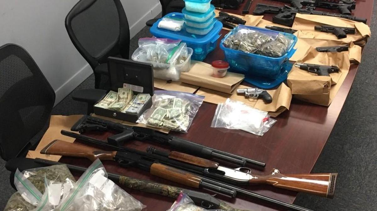 Guns, money and drugs confiscated Friday in a raid at a mobile home park by the U.S. Marshals Service and Kansas City, Kan., police.