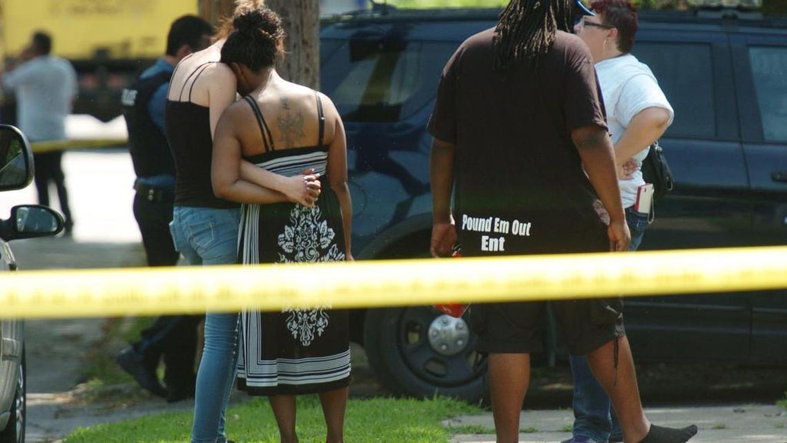 Two women hugged at the scene of a homicide in August in Northeast Kansas City.