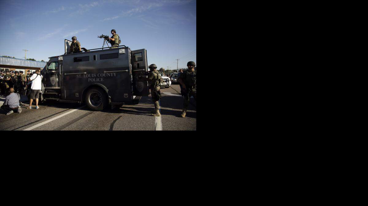 
In a lawsuit filed Thursday, police are accused of using excessive force during protests in Ferguson, Mo., after the death of Michael Brown. On Aug. 13, a police tactical team gathered near protesters. 
