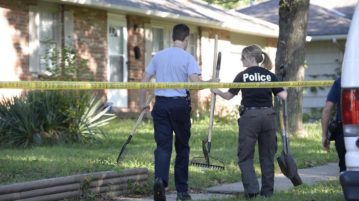 
Kansas City police search for human remains in the 9800 block of Hardesty Avenue Thursday while they investigated a missing person case from 1993. A cadaver dog was brought in to help look for the remains of Laura Mason.
