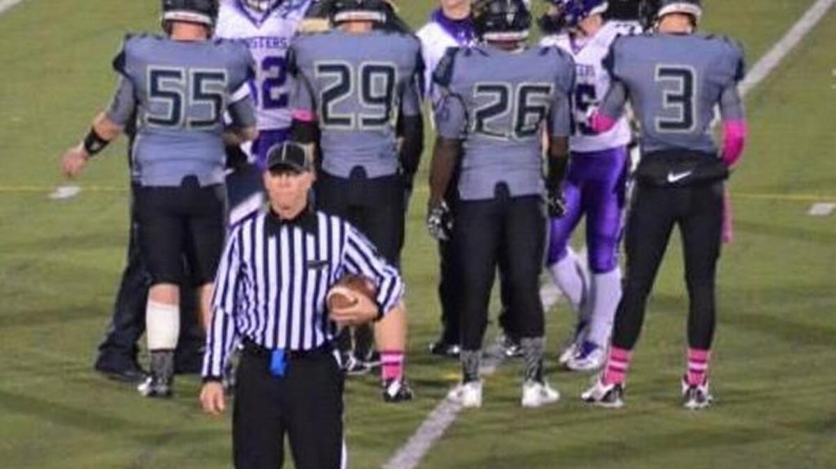 This photo of a captains’ pre-game meeting at midfield shows runningback/linebacker Tyler Eddington (No. 26) and tight end/defensive back Tristian Wilton (No. 3) representing Excelsior Springs High School.