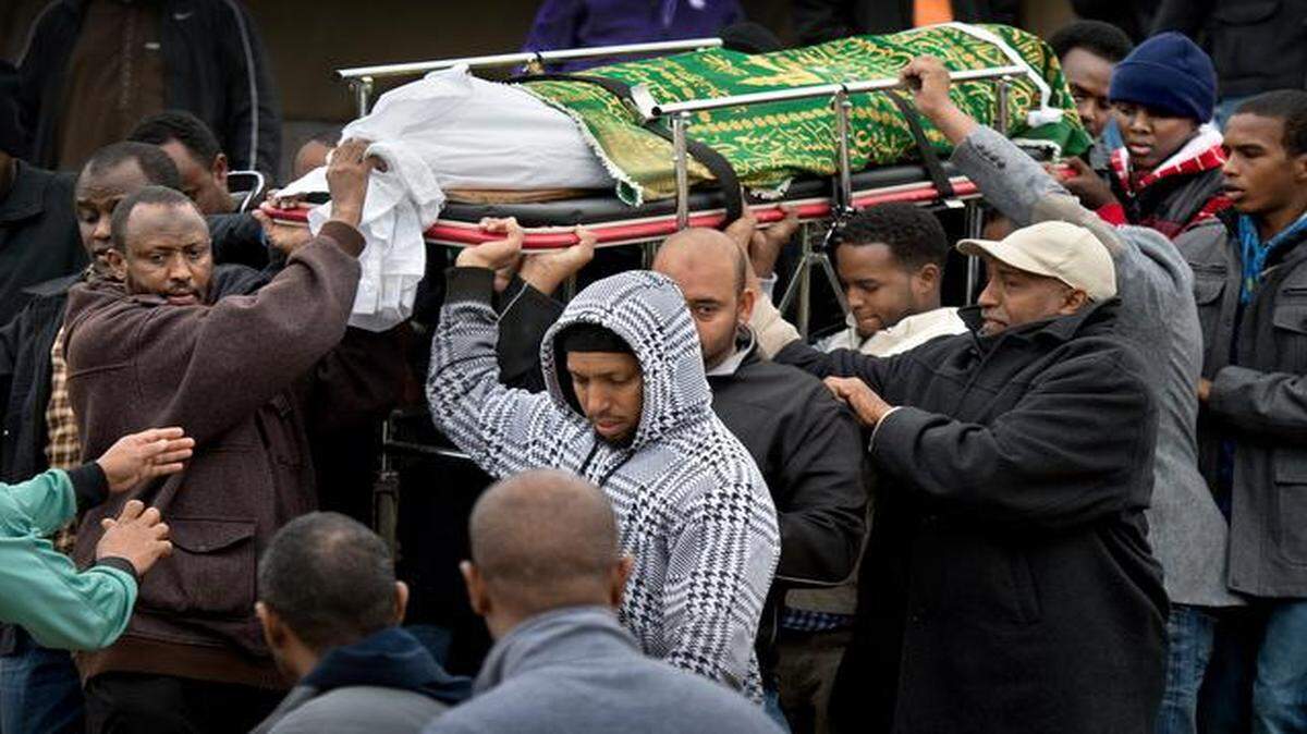 
After mourners gathered to pray for the soul of 15-year-old body of Abdisamad Sheikh-Hussein, his father, Abdullahi Mohamud (left), and other men carried the teen’s body away for burial from the Islamic Center of Greater Kansas City.