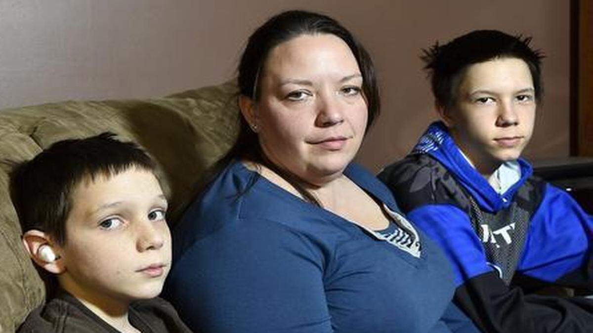 
Twelve-year-old Blake Kitchen (left) was severely beaten at Liberty Middle School. He is shown with his older brother, Preston Kitchen, and their mother, Destiny Kitchen.
