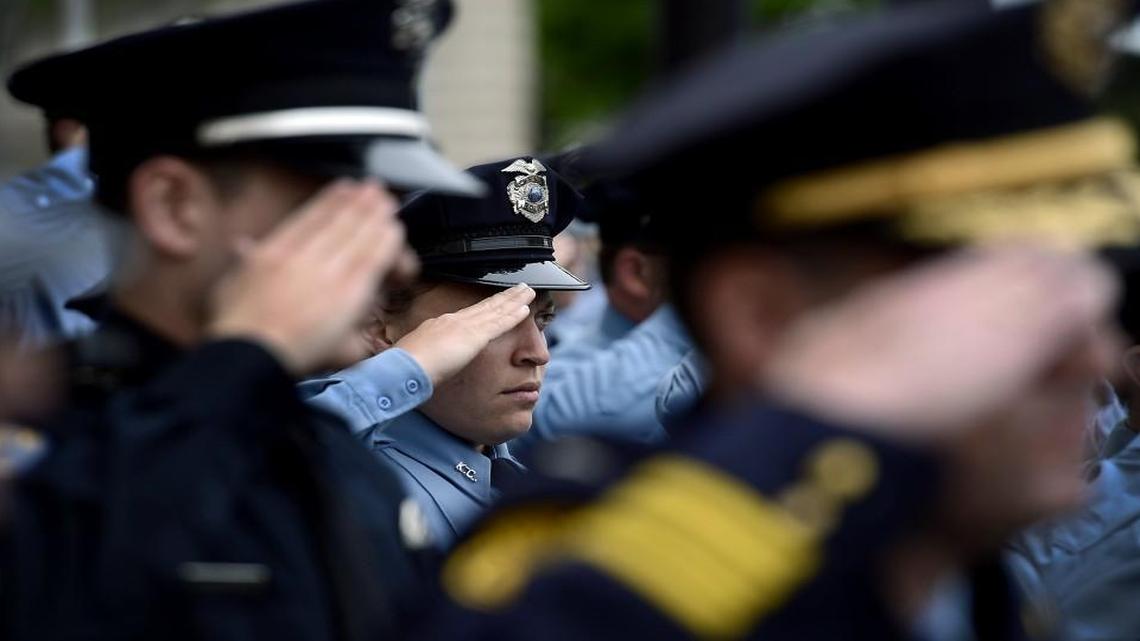 Kansas City, Kan., police officers, including Shenee Davis (middle) saluted the American flag during a 2014 memorial service for officers killed in the line of duty.