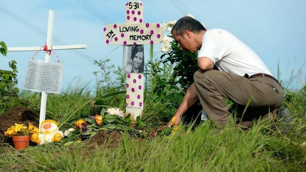 Nearby resident Farhad Mohammadi in May 2016 knelt in prayer beside a memorial for Caitlin Vogel at 191st Street and Nall Avenue in Stilwell. “God bless her soul,” Mohammadi said.