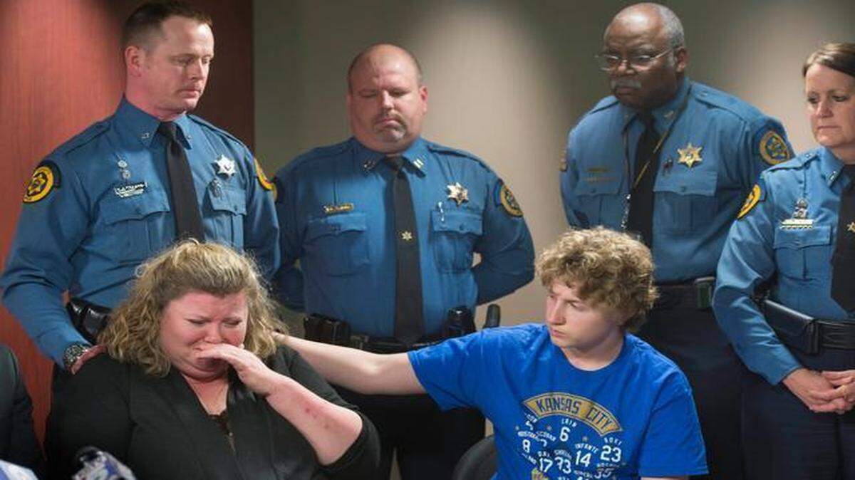 
Staci Wood held back tears Thursday as she discussed her husband, Wyandotte County Sheriff’s Deputy Scott Wood. Next to her was son Blake Wood. Showing their support were members of the Wyandotte County Sheriff’s Department, including (from left) Deputy David Toland, Capt. Daniel Soptic, Undersheriff Larry Roland and Lt. Kelli Bailiff.

