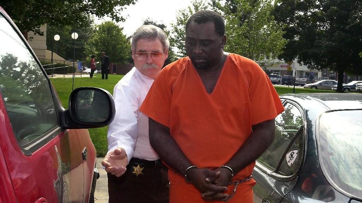 In this 2001 photo, then-sheriff Wally George escorted a prisoner to jail.