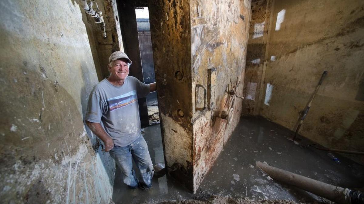 
It took two years of fighting red tape and two months of excavating concrete and water, but Russ Nielsen was determined to find out what was inside this long-ago decommissioned missile launch complex in central Missouri. In triumph, he stands by the large heavy blast door that was opened this week for the first time in 22 years. The hallway leads into the rest of the underground complex.
