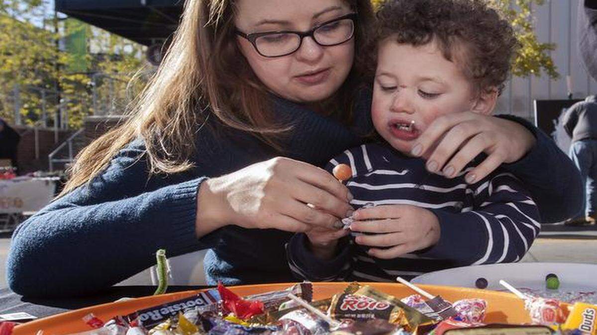 
Sara Vogt of Kansas City and her 2-year-old nephew, Ethan Francois of Liberty, used leftover Halloween candy to create art Saturday at the ArtsKC booth during ArtsKC Live in the Power and Light District.
