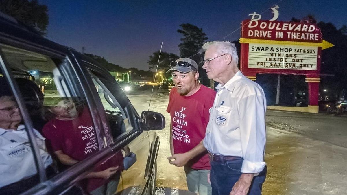 
Brian (left) and Wes Neal had to turn away drivers from the sold-out show last Saturday at the Boulevard Drive-In Theatre in Kansas City, Kan. Owner Wes Neal started working at the theater in 1954, making $3 a night. Now 87, he continues to take tickets and roam the grounds, but he has handed over most of the business to his grandson, Brian Neal.
