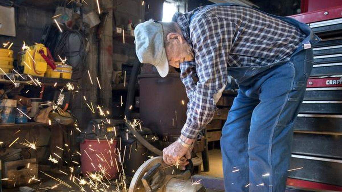 At age 94, Charles Bradley may just be the oldest farmer still working around Platte County. Here he trims a piece of steel rebar in his shop on his farm north of Weston.