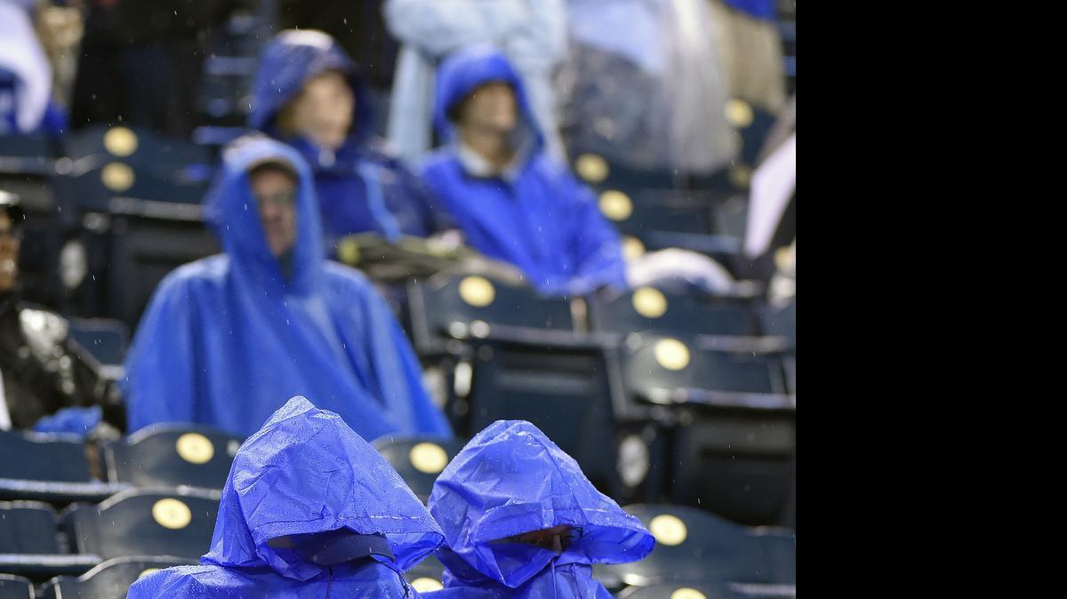 
Kansas City Royals fans sit in their seats while waiting through a sixth inning rain delay during Saturday's baseball game against the St. Louis Cardinals on May 23, 2015 at Kauffman Stadium in Kansas City, Mo.

