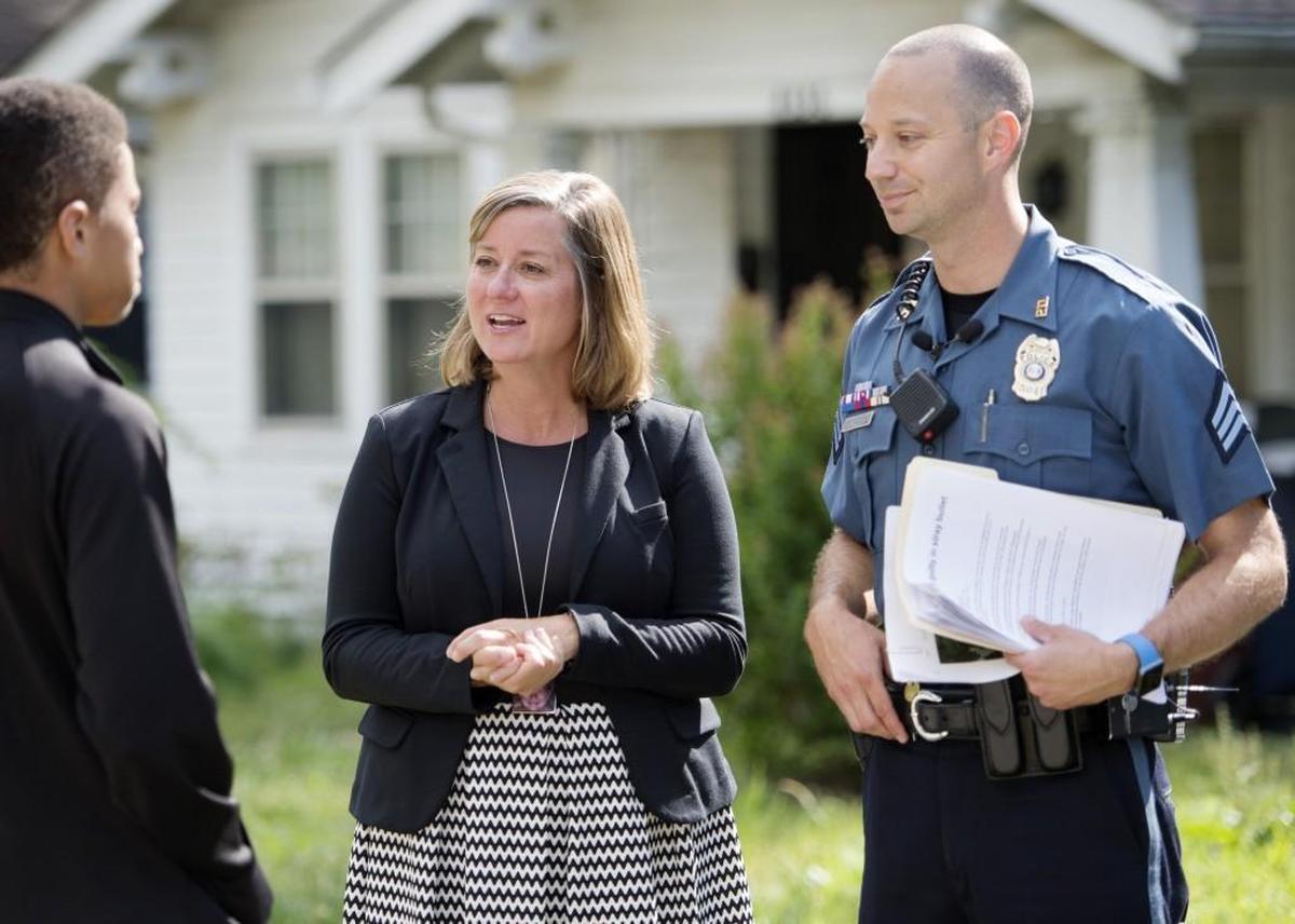 In this file photo, Officer Jake Becchina explained the dangers of celebratory gunfire to Mekai Kelly, 16, of Kansas City. Michele Shanahan DeMoss, whose 11-year-old daughter Blair Shanahan Lane was killed in 2011, has gone door to door with police three years in a row to help educate the public.