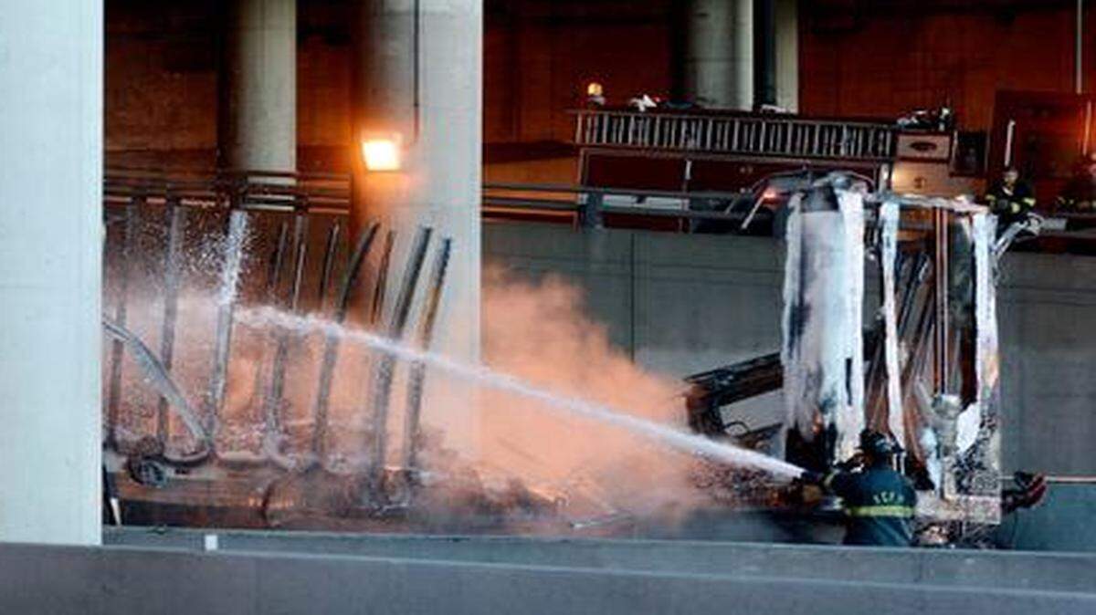 
A firefighter douses the remains of a tractor trailer early Saturday morning in the downtown loop just under Broadway.
